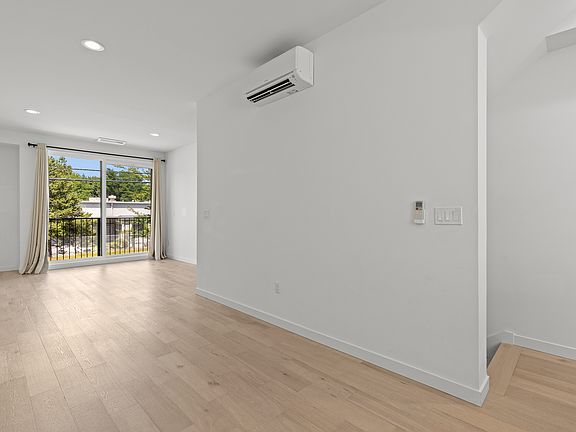 Open floor plan with plenty of room for dining area off kitchen and living room beyond.