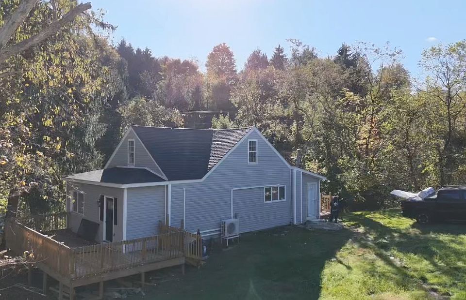 Front view of entrance of home and side view of front porch