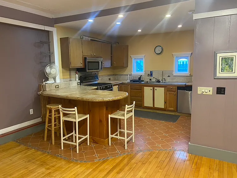 Efficient kitchen with island propane stove dishwasher large fridge