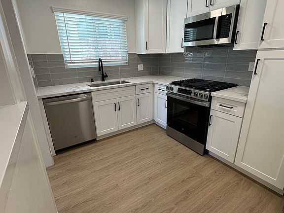 Plenty of space for a bar cart or extra counter in the corner under the bar