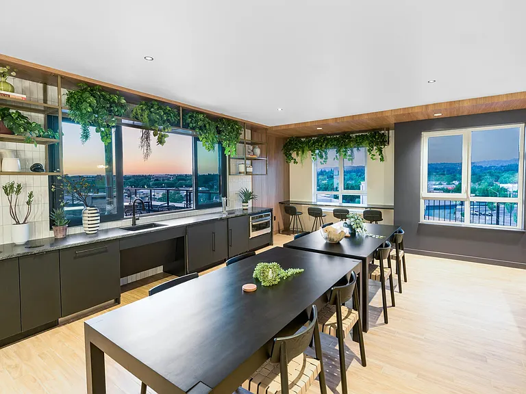 Host with ease in the elevated clubroom at Modera Beaverton, featuring sleek finishes and panoramic city views.