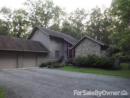 Front View
						:
						The front of the house has beautiful, mature landscaping.