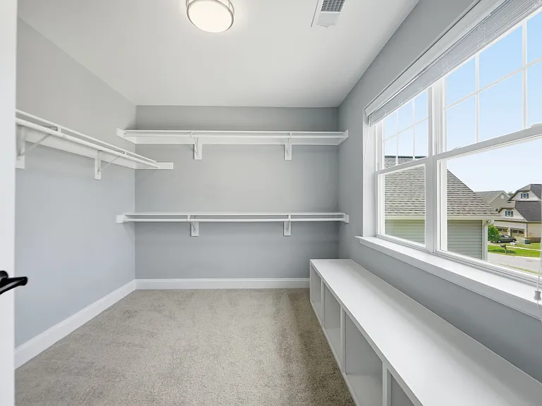 Massive walk in master closet with seating.