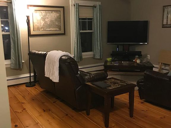 Open concept living room. Original wide pine floors from ear