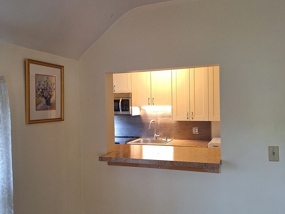 Pass through window/breakfast bar between kitchen and living room.