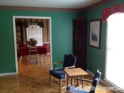 Living room features a full-length window, custom cornice & 2" blinds.