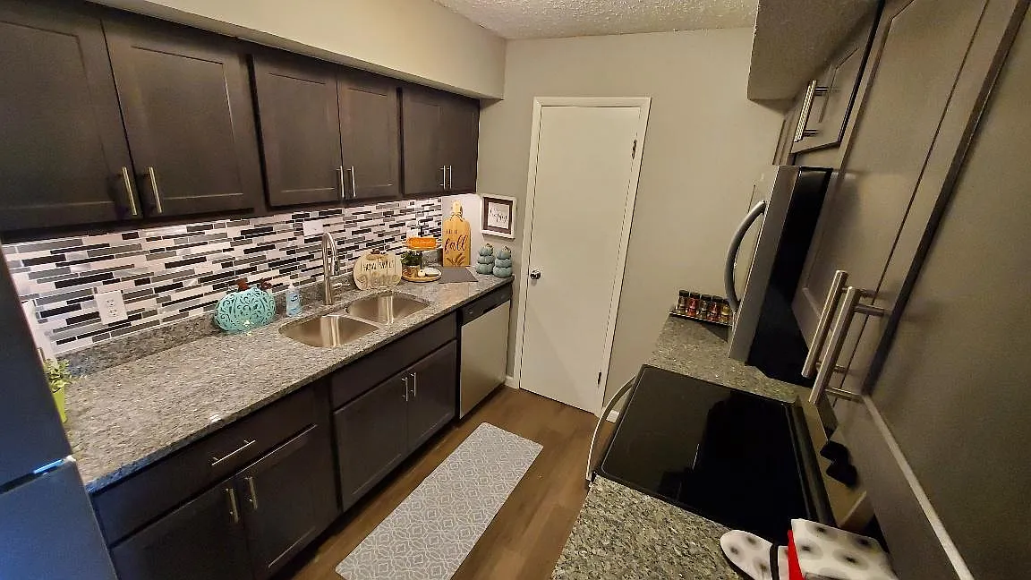 New Kitchen with Gray Slate Cabinets and Caledonia Granite Countertops. Also includes all new stainless steel appliances.