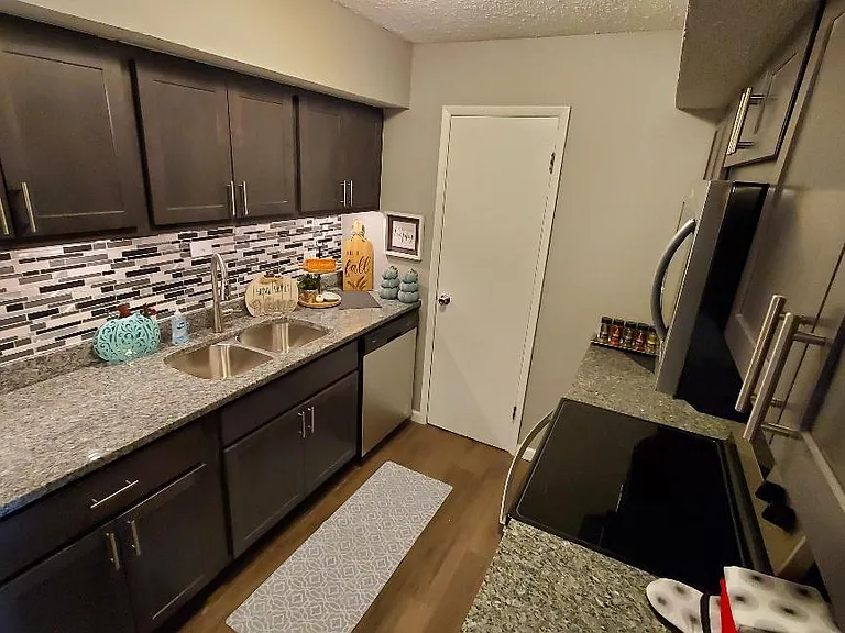 New Kitchen with Gray Slate Cabinets and Caledonia Granite Countertops. Also includes all new stainless steel appliances.