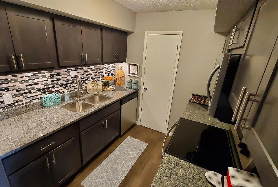 New Kitchen with Gray Slate Cabinets and Caledonia Granite Countertops. Also includes all new stainless steel appliances.