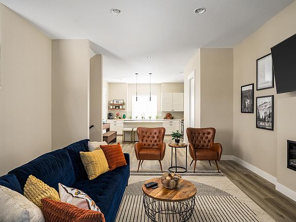 Living room with view into kitchen