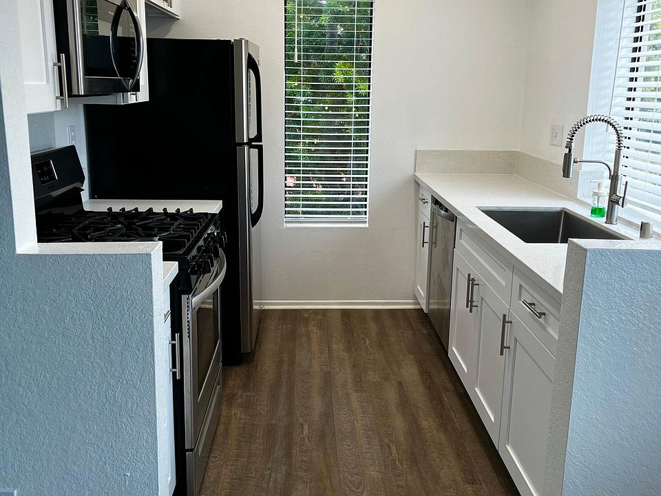 Remodeled kitchen with new cabinets, quartz counter tops, and recessed LED lighting