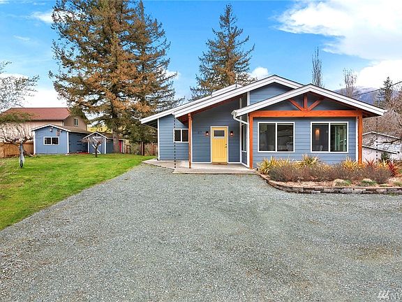Outbuildings on the edge of the lot. Tons of parking in front of home. 