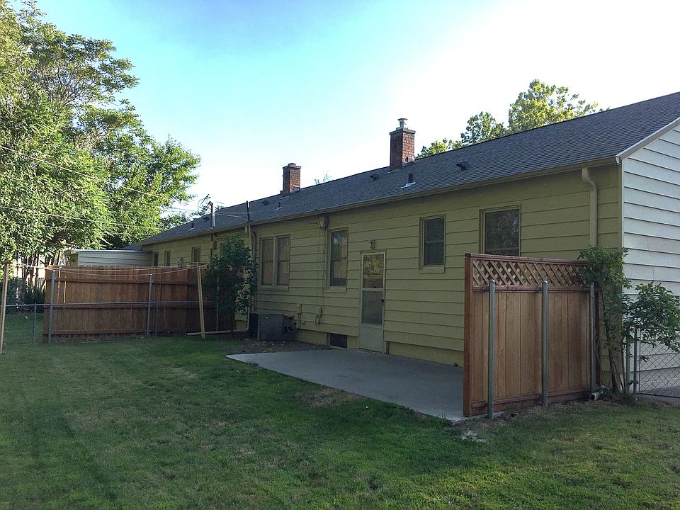 Mature backyard with numerous shade trees on all surrounding properties.