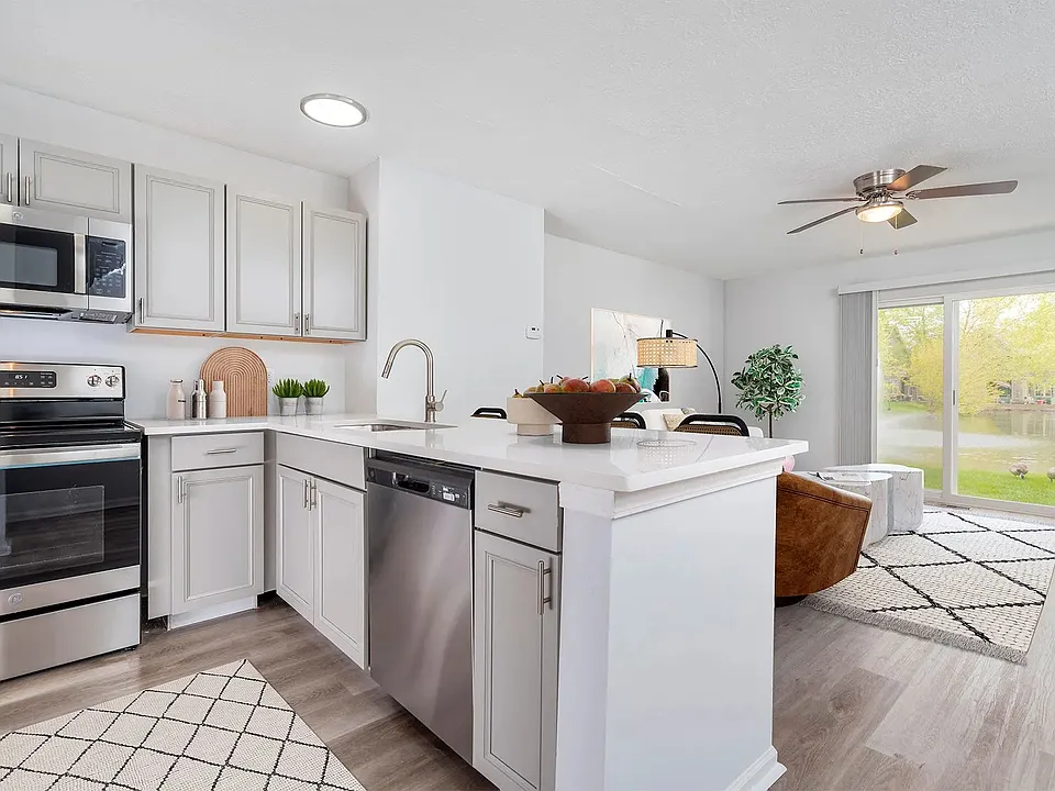 Premium Trentwood kitchen with grey cabinetry, granite countertops, and stainless-steel appliances.