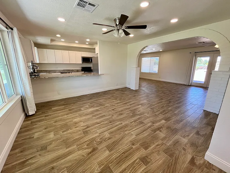 Living area open to kitchen, lots of natural light. New ceiling fans, recessed lights. All brand new windows installed recently.