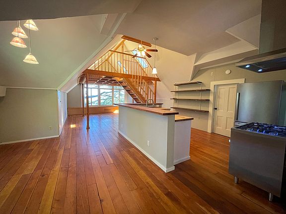 another view into the kitchen with original hardwood floors.