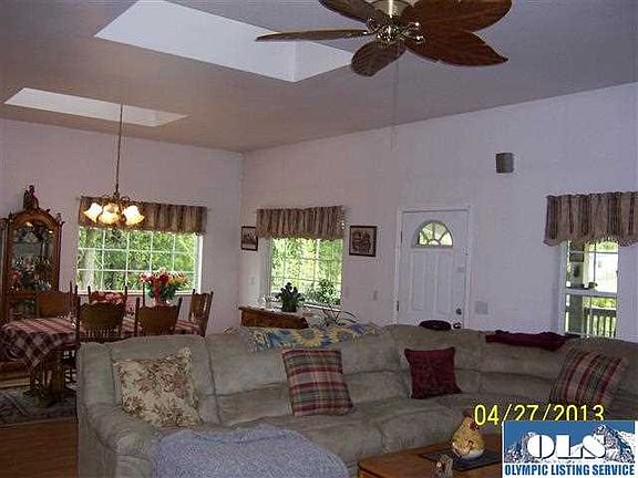 Most ceiling fans are a prominent feature in this home. The heating is provided by hot water heated coils under the flooring. Nice for the feet in the winter. Additionally the bedrooms and baths have wall heaters. This shot is of the living area. This really is a great room design. 