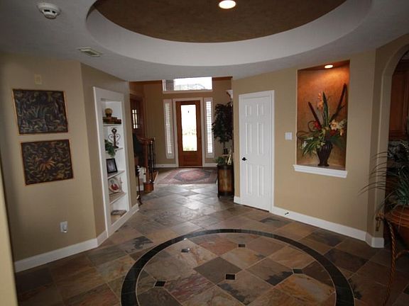 Attractive inlayed-granite tile is set into the slate floors under the rotundra. An art niche and an