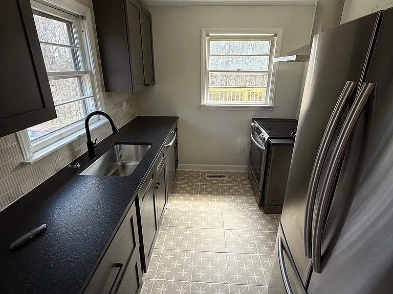Newly remodeled kitchen with granite countertops, stainless steel appliances and tiled backsplash