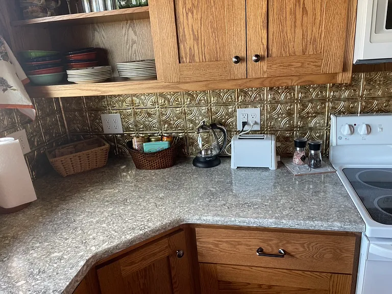 Quartz countertops. Was used as an AirBnB, so shown with dishes and small appliances.