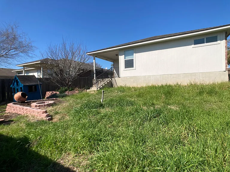 back yard, (will be mowed soon) fully enclosed, fence will have repairs
