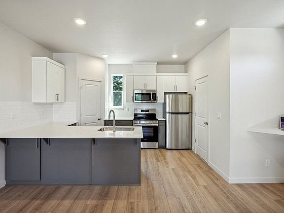 Kitchens include a large pantry and half-bathroom.