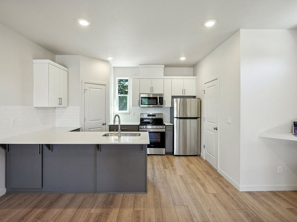 Kitchens include a large pantry and half-bathroom.