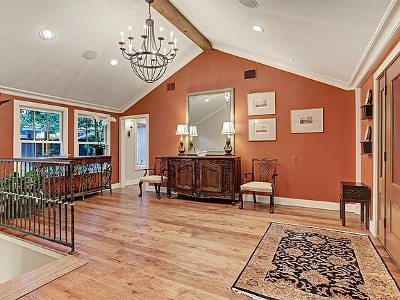 The Formal Entry was completely renovated and expanded in 2013/2014. The beamed vaulted ceiling creates a dramatic area for greeting guests. Custom iron railings lead to steps down to the kitchen. Original wood railing leads to steps in the main Livi