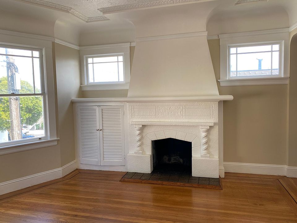 Elegant fireplace in the living room with windows facing west and north, bring in lots of natural light.