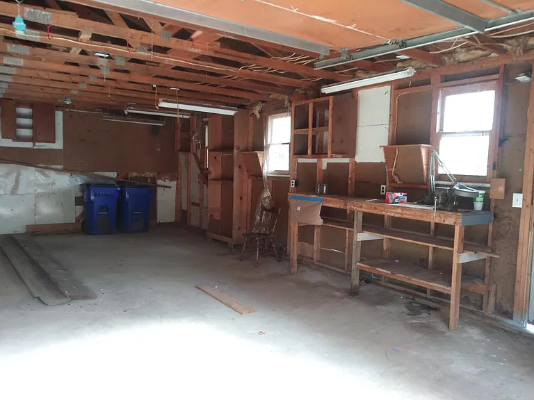 Inside garage showing work bench and storage space