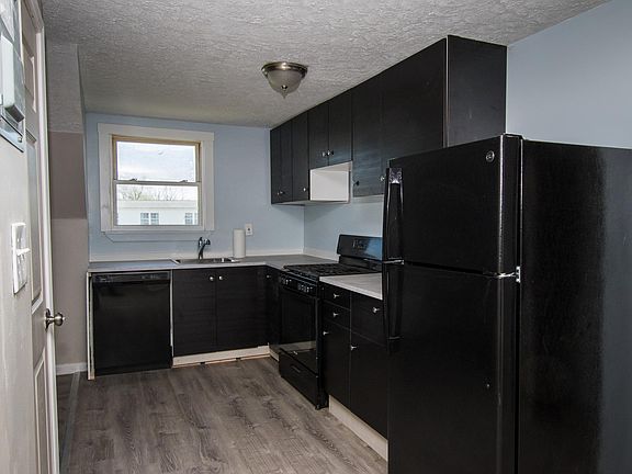 Kitchen with dishwasher, gas stove and fridge