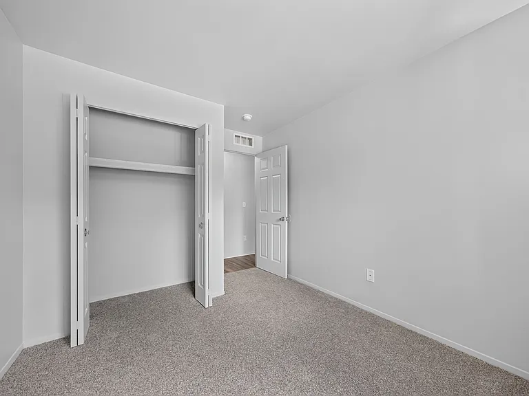 Cozy bedroom with ample storage at Woodland Villa Apartments in Westland, MI.