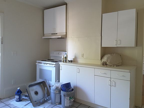 Kitchen stove & cabt wall with remodel material in photo