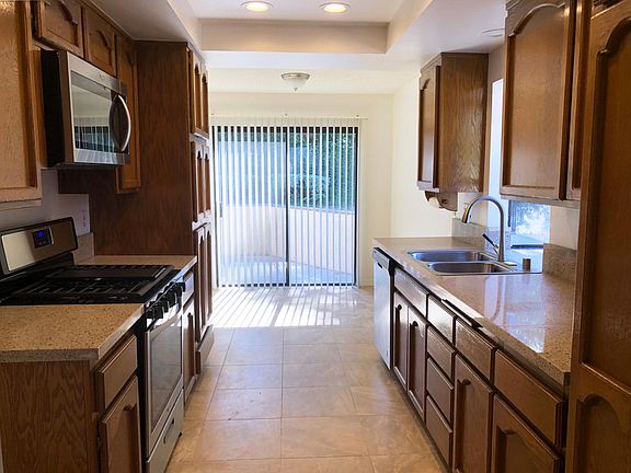 Recently remodeled kitchen with new dishwasher, microwave, oven/stove, flooring and countertops.