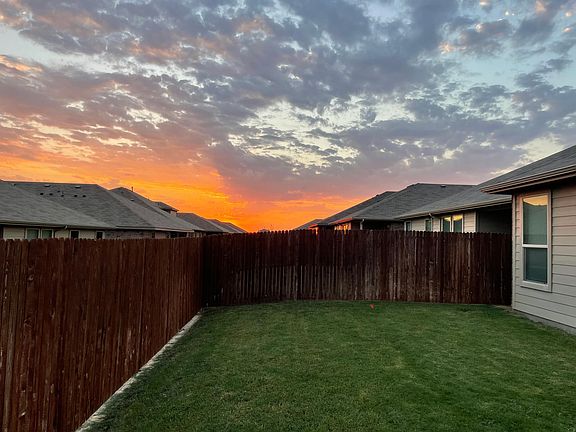 Large grass back yard on sprinkler system.