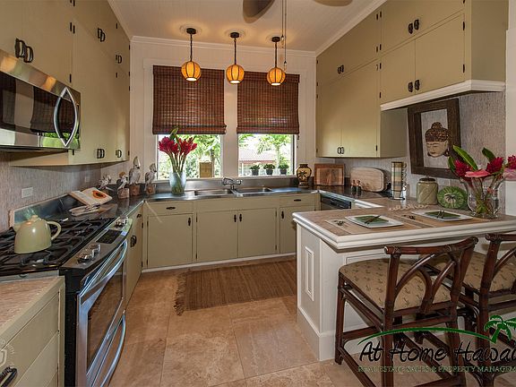 The chef's kitchen features a gas cooktop and a dishwasher for easy clean up.