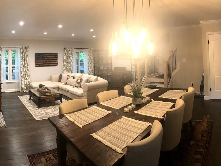 Living/Dining Room. *Note stairs are now stained same color as floors, photo taken prior to completion of renovation.