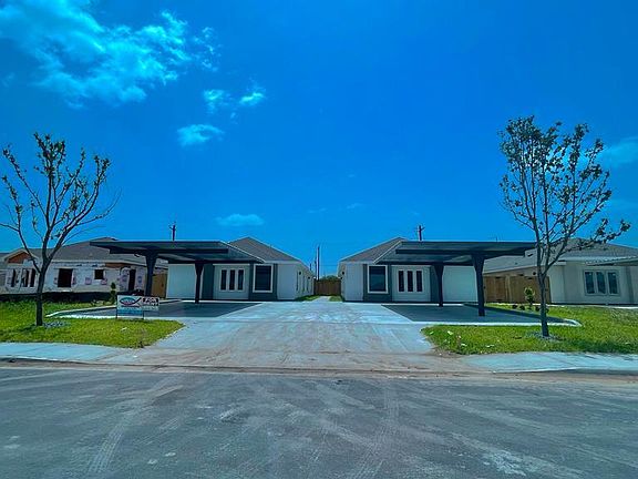 Front Entrance to 4 plex w/covered parking. Security lights under parking area. 2 designated parking areas/unit.