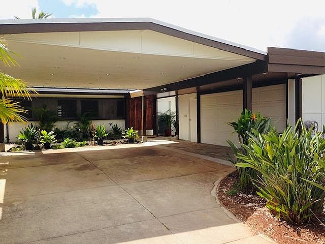 Large 2 car garage with room for an additional 2 cars under the car port.