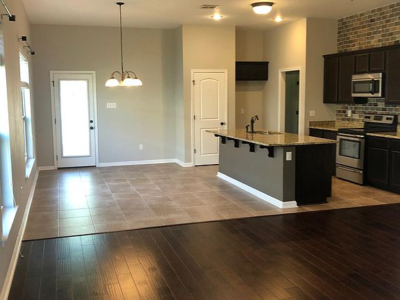 Open floor plan with wood and tile flooring