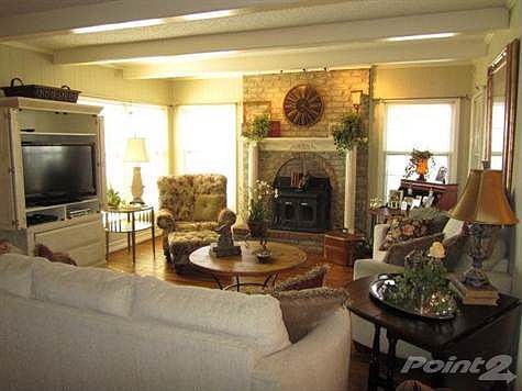 The spacious Living Room features recently installed hand scraped hardwood flooring.