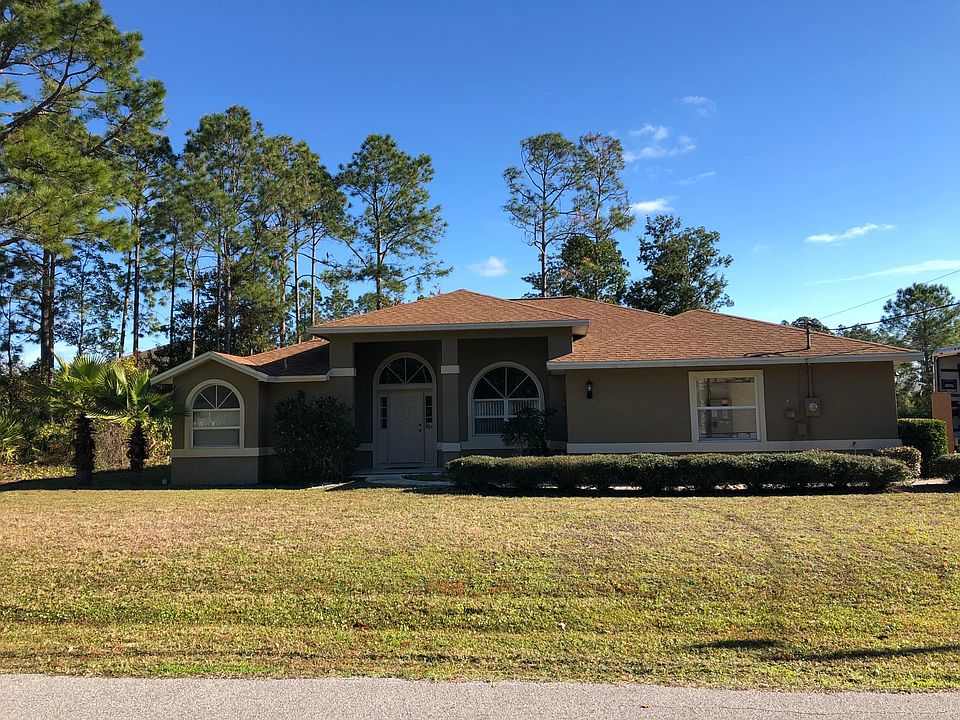 Front view, 3/2 with a bonus room, living, dining, family, lanai, laundry room, 1 acre corner lot 2 car garage