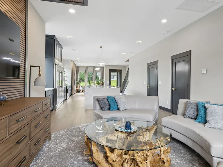 entry floor living room opens to kitchen and dining room, powder bath.