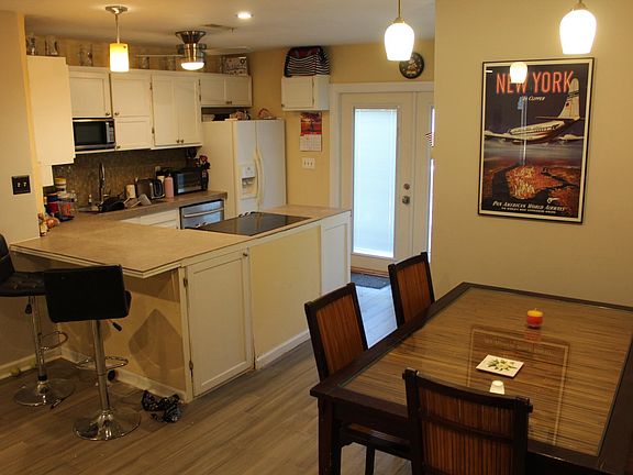 Open kitchen design. Walls arond kitchen removed during renovaton for more airy feel and more light from back french doors that lead out onto deck