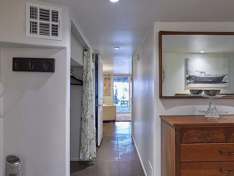 Hall with Large Hanging Closet and Pantry. View to the Patio.