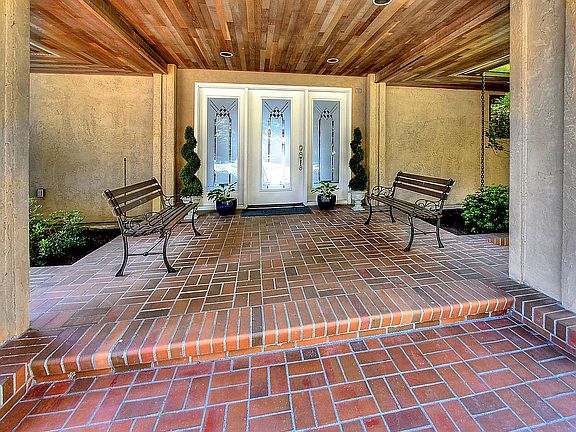 Large covered entry with recessed ligting.