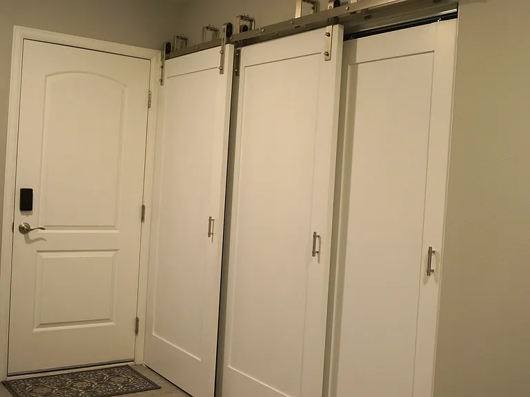 In kitchen laundry. Washer, dryer and hot water heater are hidden behind sliding wood barndoors. Metal fire rated door to garage.