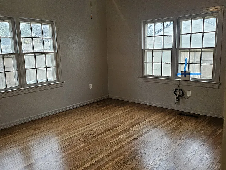 Downstairs back bedroom with 10 foot ceilings and private back door