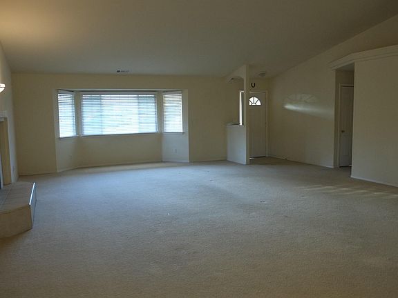 Living room. Carpet has been replaced with wood planks.