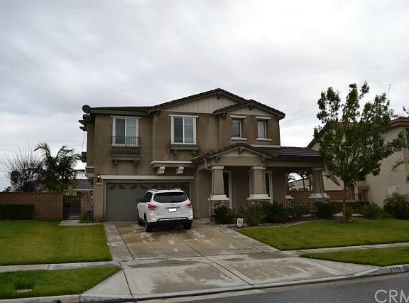 Front of home with large yard and beautiful mountain views